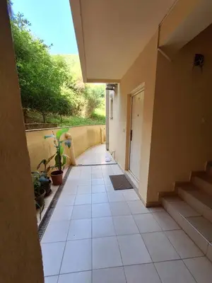 a hallway of a house with stairs and plants at Ljiljana in Petrovac na Moru
