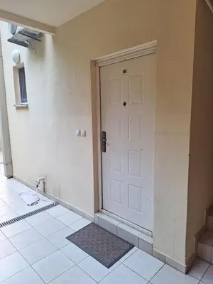 an empty room with a white door and a tile floor at Ljiljana in Petrovac na Moru