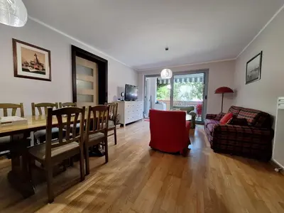 a dining room and living room with a table and chairs at Ljiljana in Petrovac na Moru