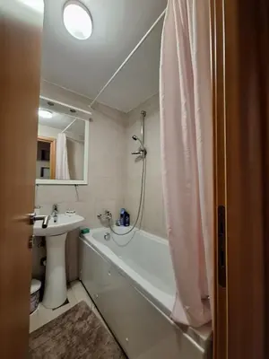 a bathroom with a tub and a sink and a bath tub at Ljiljana in Petrovac na Moru