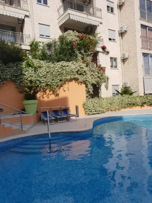 a swimming pool in front of a building at Ljiljana in Petrovac na Moru