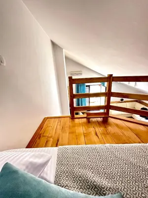a bedroom with a bed and a wooden floor at PalmOliva in Rafailovici