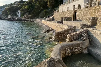 a group of steps next to a body of water at Sea Salt Apartment in Kruče