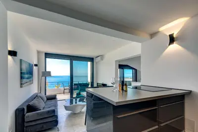 a kitchen and living room with a view of the ocean at Sea Wave Apartment in Kruče