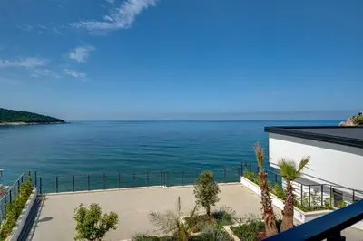 a view of the ocean from the balcony of a house at Sea Wave Apartment in Kruče