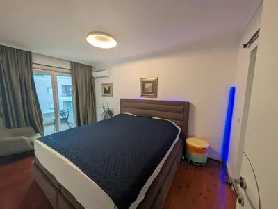 a bedroom with a large bed in a room at Penthouse NIKOLA in Budva