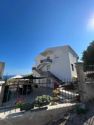 a white building with stairs in front of it at Apartments Andrović in Ulcinj