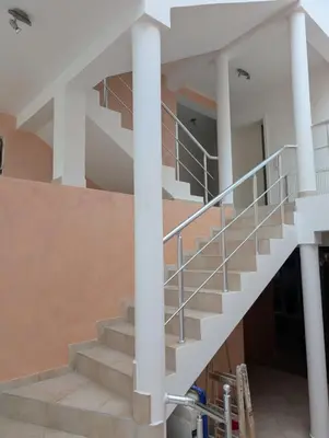 a staircase in a building with white columns at Vila Anja in Dobra Voda