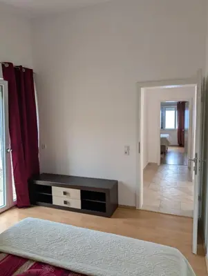 a room with a bed and a living room at Vila Anja in Dobra Voda