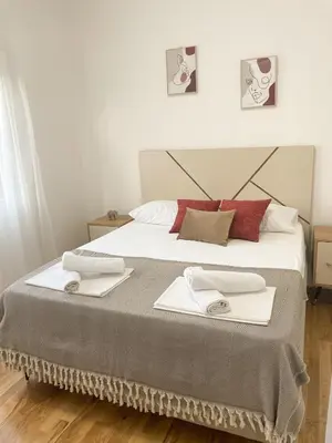 a bedroom with a large bed with two towels on it at Le Vacanze in Ulcinj