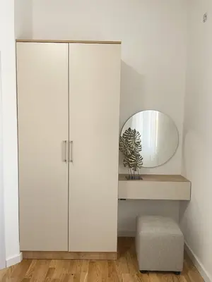 a white cabinet in a room with a mirror at Le Vacanze in Ulcinj