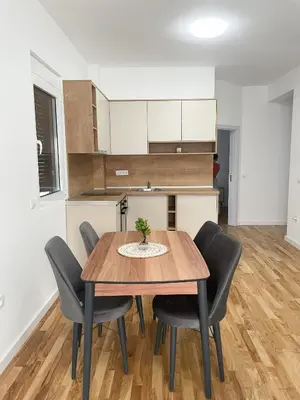 a dining room with a wooden table and chairs at Le Vacanze in Ulcinj