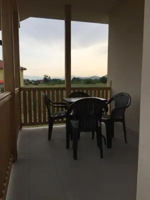 a balcony with a table and chairs and a view at Monimont in Golubovci