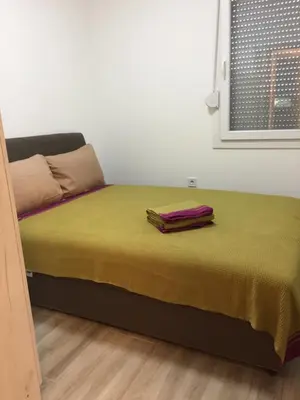 a bed with two towels on it in a room at Monimont in Golubovci