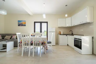 a kitchen and dining room with a table and chairs at Villa Jovana in Zagora