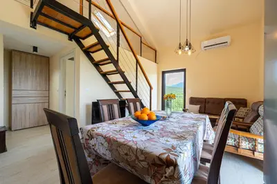 a dining room with a table with a bowl of oranges on it at Villa Jovana in Zagora