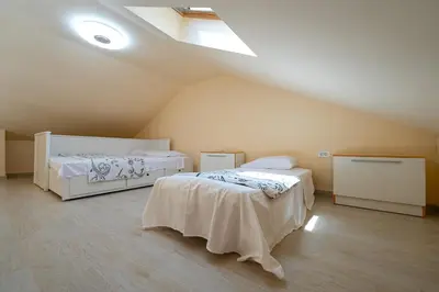 a attic room with two beds and a skylight at Villa Jovana in Zagora