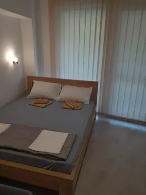 a bedroom with a bed with two towels on it at Apartman Tijana in Sutomore