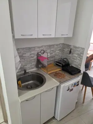 a small kitchen with a sink and a counter at Apartman Tijana in Sutomore