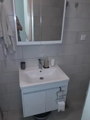 a bathroom with a white sink and a mirror at Apartman Tijana in Sutomore