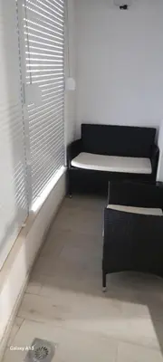 a living room with a couch and a window at Apartman Tijana in Sutomore