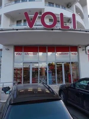 a car parked in front of a vox store at Apartman Tijana in Sutomore