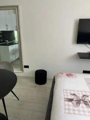 a bedroom with a bed and a mirror at Lux Cotton in Podgorica