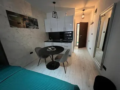 a small kitchen with a table and chairs in a room at Lux Cotton in Podgorica