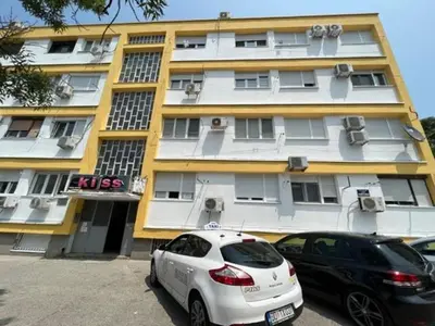 two cars parked in front of a building at Lux Cotton in Podgorica