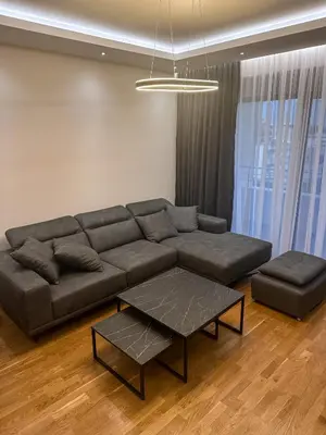 a living room with a couch and a coffee table at Enigma Apartment in Ulcinj