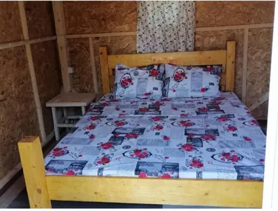 a bedroom with a bed with a wooden bed frame at House Markovic in Gornja Plavnica