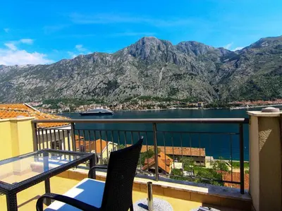 a balcony with a view of the water and mountains at Sea view and pool! Brend new! Vista in Kotor