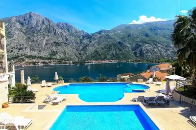 a pool with a view of a lake and mountains at Sea view and pool! Brend new! Vista in Kotor