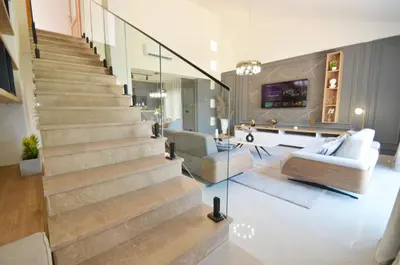 a staircase in a living room with a couch and chairs at Boka Devine Residence in Kotor