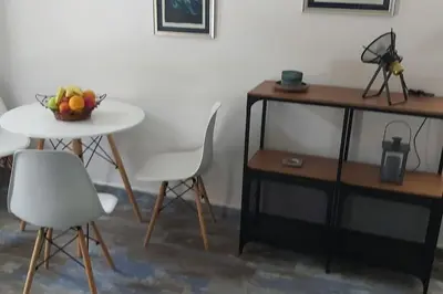 a table and chairs with a bowl of fruit on a table at Villa Hedonic in Ulcinj