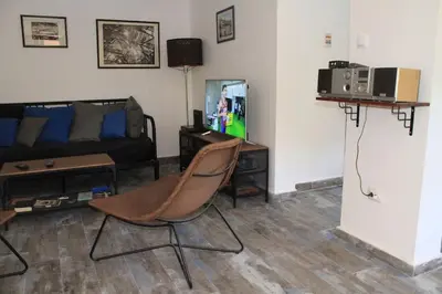 a living room with a couch and a chair and a tv at Villa Hedonic in Ulcinj