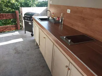 a kitchen with a counter with a sink and a stove at Villa Hedonic in Ulcinj