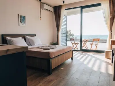 a bedroom with a bed with a view of the ocean at Hayal Boutique Hotel in Bar