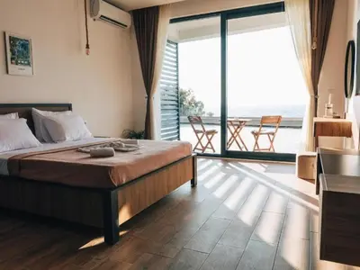 a bedroom with a bed with a view of the ocean at Hayal Boutique Hotel in Bar