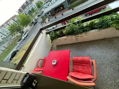 two red chairs and a table on a balcony at Apartment in Podgorica - Montenegro in Konik