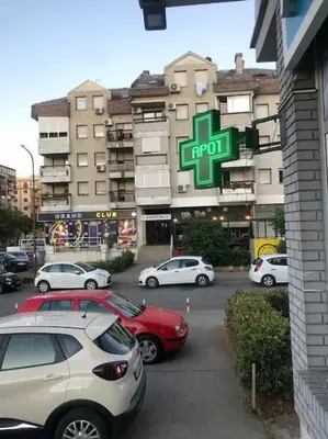 a parking lot with cars parked in front of a building at Apartment in Podgorica - Montenegro in Konik