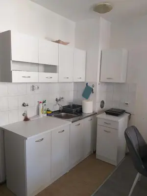 a white kitchen with white cabinets and a sink at Apartment in Podgorica - Montenegro in Konik