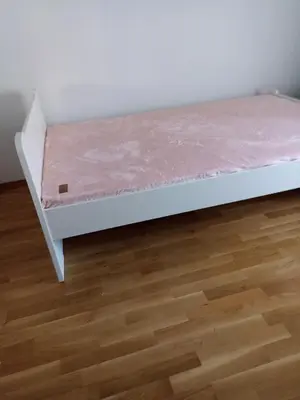 a bed with a pink mattress on top of a wooden floor at Sofia apartment in Budva