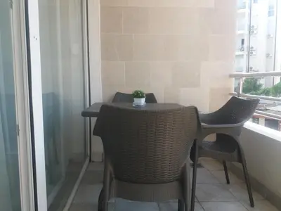 a small table and chairs in a balcony with a window at Sofia apartment in Budva