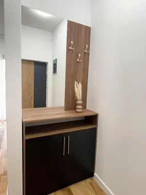 a bathroom with a black cabinet and a mirror at Le Vacanze 2 in Ulcinj