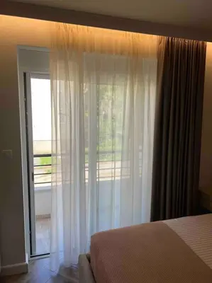 a bedroom with a bed and a sliding glass door at Sunshine of Montenegro - Luxury in Kotor
