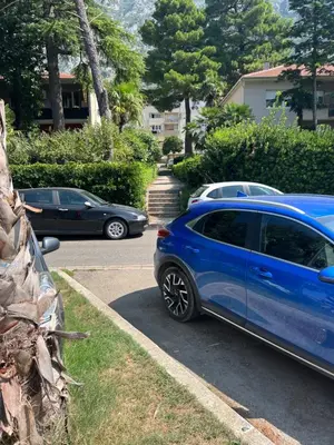 a blue car parked in a parking lot at Sunshine of Montenegro - Luxury in Kotor
