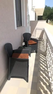 two chairs and a table on a balcony at Becic Apartments in Ulcinj