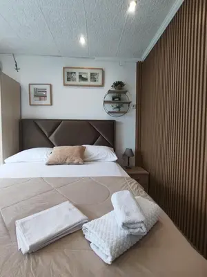a bedroom with a bed with two towels on it at Becic Apartments in Ulcinj