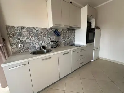 a white kitchen with a sink and a refrigerator at Summer Apartment Petrovac in Petrovac na Moru